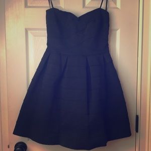 Textured strapless black dress.